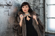 Beautiful woman with luxury hair wearing fur coat and jewelry
