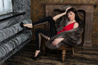 Fashion model wearing fur coat and posing in a vintage room