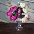 pink ranunculus (persian buttercup) in glasses on the wood table