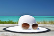 Photo: Hat and sunglasses on the beach of Exuma, Bahamas Hat and sunglasses on the beach of Exuma, Bahamas