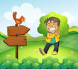 A boy smiling in the garden with a wooden arrow board