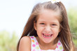 Funny toothless little girl outdoors