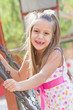 Funny toothless little girl on a playground