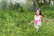Funny little girl running in the park