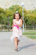 Funny little girl running in the park