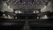Man applauds alone in the theater.