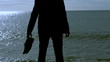 Businessman silhouette standing on a sunny beach in the morning,