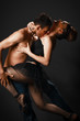romantic tango dancing couple on black