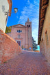 Old church and narrow street. Monticello D'Alba, Italy.