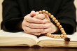 Priest reading from the holy bible, close up