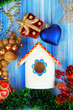 Nesting box and Christmas decorations on blue background