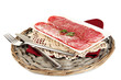Tasty salami on plate on  wicker cradle isolated on white
