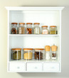 Beautiful white shelves with spices in glass bottles