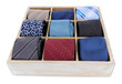 Neckties in wooden box isolated on white