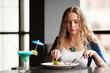 Beautiful young woman dining at a restaurant