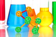 Molecule model and test tubes with colorful liquids close up