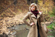 Young blond woman in autumn forest