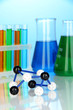 Molecule model and test tubes with colorful liquids