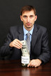 Photo: Young businessman with money on black background. Young businessman with money on black background.