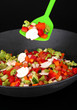 Vegetable ragout in wok, isolated on black