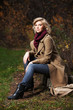 Young blond woman in autumn forest