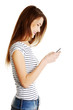 Young smiling caucasian tenn using cell phone