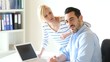 Business people working in office on laptop
