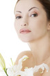 Woman with health skin and with lily flower