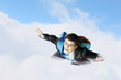 Young businessman flying with parachute on back