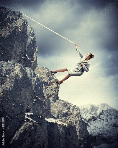 Photo: businesswoman climbing mountain businesswoman climbing mountain