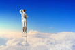 Businesswoman standing on ladder