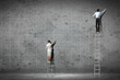 businesspeople drawing diagrams on wall