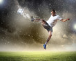 Photo: football player striking the ball football player striking the ball