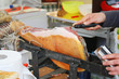 Seller slicing prosciutto