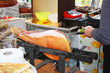 Seller slicing prosciutto