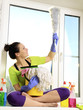 Foto: Women cleaning a window Women cleaning a window