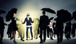 Businesswoman in blindfold among group of people