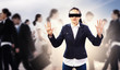 Businesswoman in blindfold among group of people