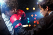 Two young businessman boxing