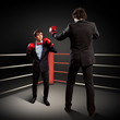 Two young businessman boxing