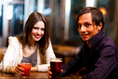 Photo: Friends having a drink in a pub Friends having a drink in a pub