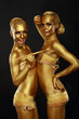 Fancy Dress Party. Women with Golden Metallic Painted Skin