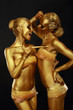 Photo: Gilt. Women with Paintbrush. Futuristic Glossy Gold Make-up Gilt. Women with Paintbrush. Futuristic Glossy Gold Make-up