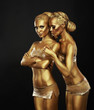 Bodyart. Girlfriends with Golden Makeup in Embrace. Art Deco