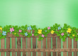 Wooden fence with a flower garland on the abstract background of
