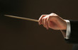 Concert conductor's hands with a baton