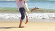 Close Up Of Senior Man Picking Up Senior Woman At Waters Edge