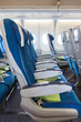 Comfortable seats in aircraft cabin with screens in chairs back