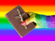 Old hand (woman) holding a very old bible, rainbow flag