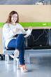 Photo: Happy woman charging her electronic devices in place to charge Happy woman charging her electronic devices in place to charge